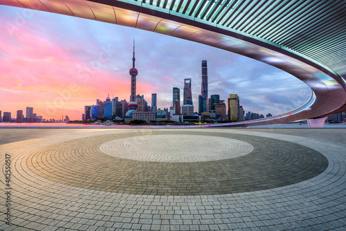 Panoramic skyline and modern commercial buildings with empty square floor in Shanghai at sunrise, Ch